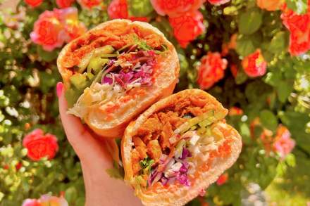Image of someone holding a sandwich from Buds (a vegan restaurant in Salt Lake City)