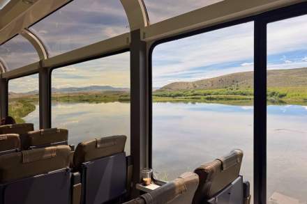 Image of the Canyon Spirit railway passing a lake.