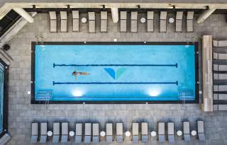 Aerial photo of the pool at the Cliff Spa with a swimmer