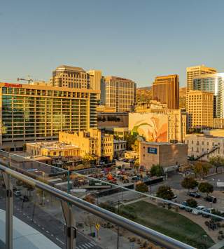 A view of downtown Salt Lake from the 6th floor of the Hyatt Regency. Buildings, one with a mural, bathed in golden light