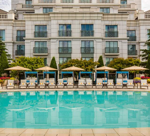 Pool side view of pool, lounge chairs, and hotel at the Grand America Hotel in Salt Lake City