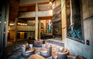 Lobby of the Iron Blosam lodge showing a painting and several lounge chairs