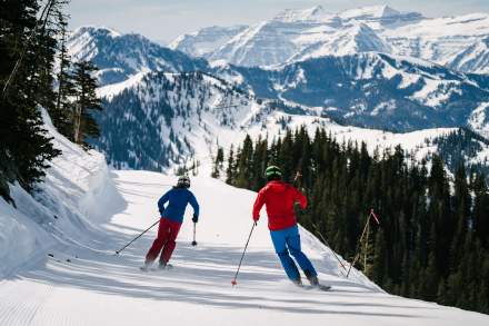 Two skiers on a narrow run
