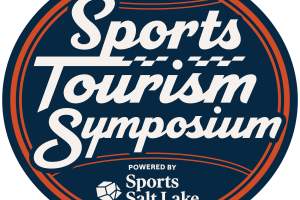 Ball with the words Sports Tourism Symposium powered by Sports Salt Lake on it