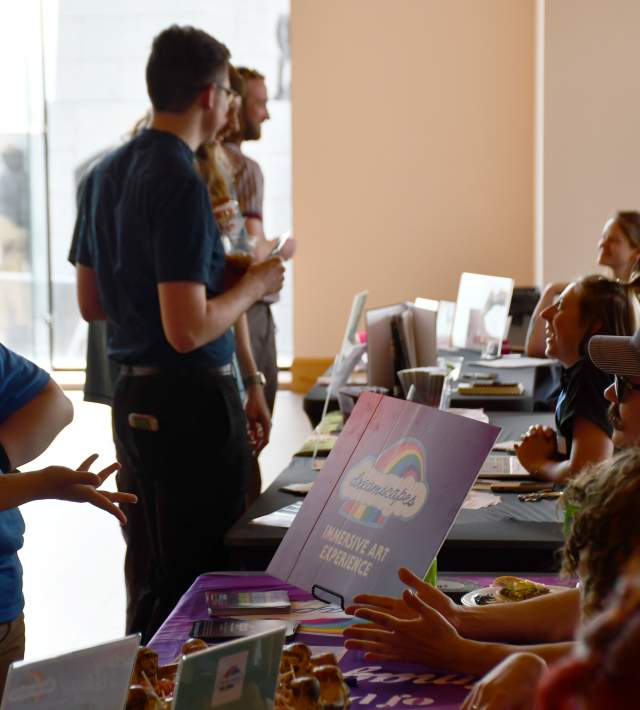 Information tables set up with a crowd of people in front of them