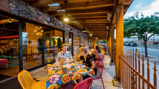 Image of people eating on the patio of Red Iguana 2