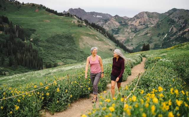 Image of two women walking through Alta Wildflowers