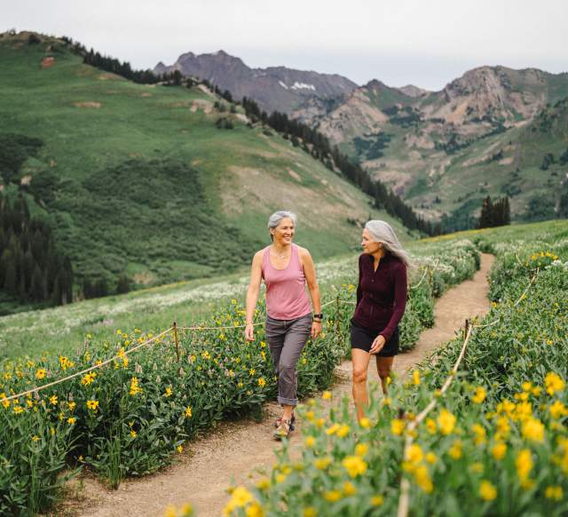 Image of two women walking through Alta Wildflowers