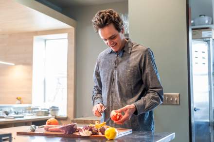Milo Carrier preparing food in the kitchen at Avenues restaurant, Arlo