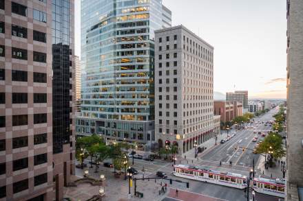 View of Salt Lake City main street with Trax light rail on the street and and early sunset sky