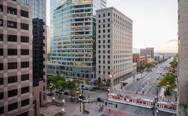 View of Salt Lake City main street with Trax light rail on the street and and early sunset sky