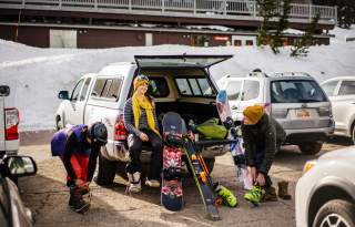 Friends getting ready in parking lot to ski at Brighton