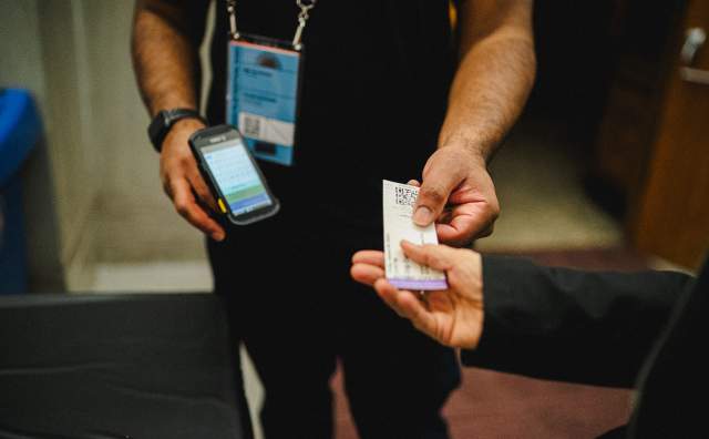 Person getting ticket scanned for admission